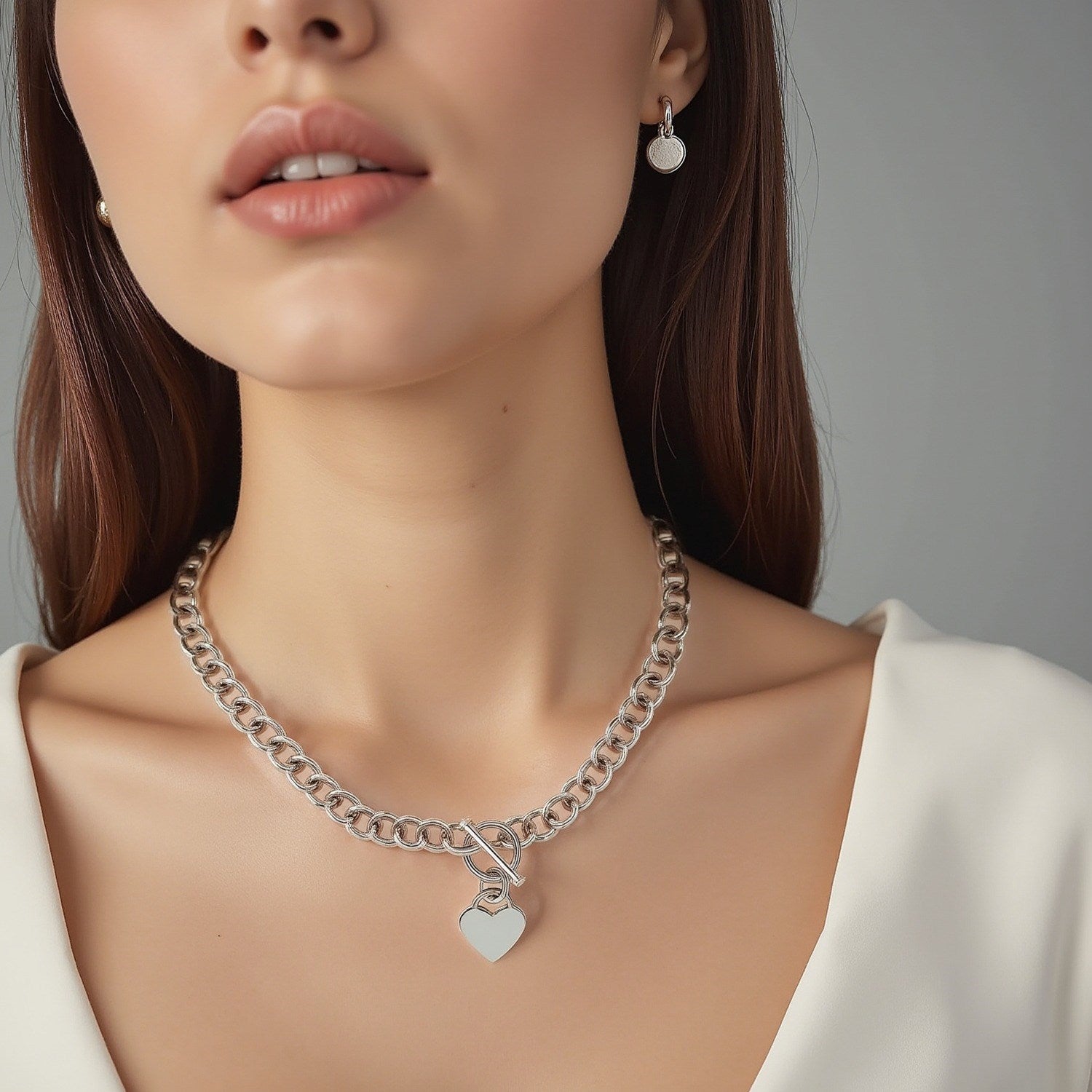 Sterling zilveren Rolo-ketting met een hartvormige schakelbedel en rhodium-plating