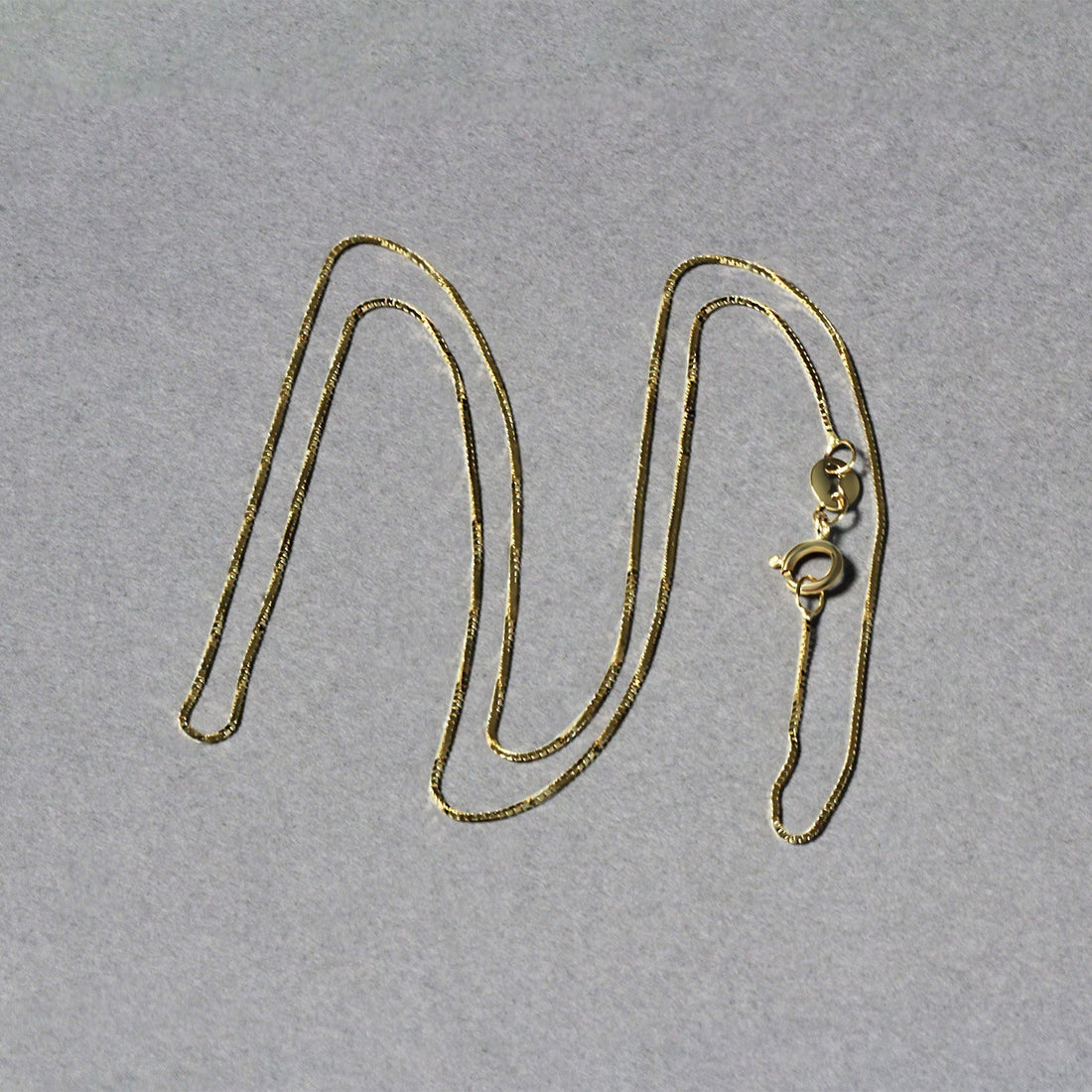 Chaîne classique en or jaune 14 carats (0,60 mm)